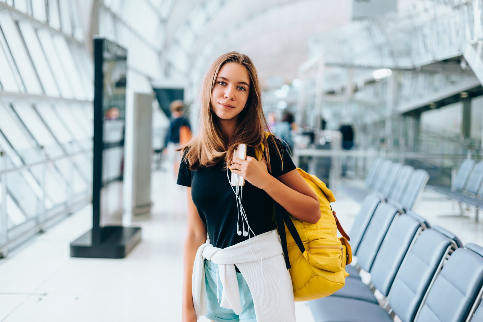 Teen Girl Waiting for Flight in Airport